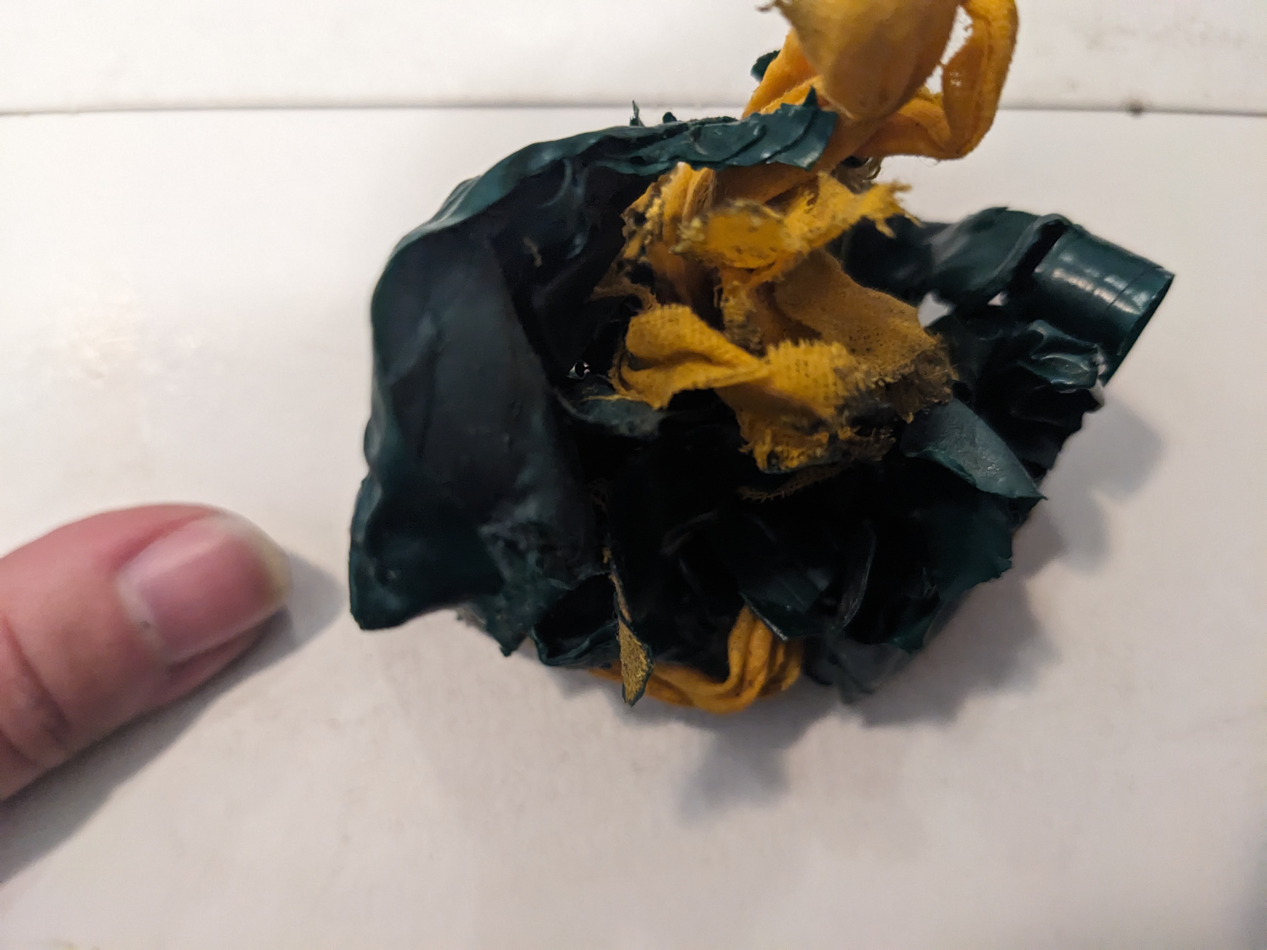 Big blob of old tape, hand for scale