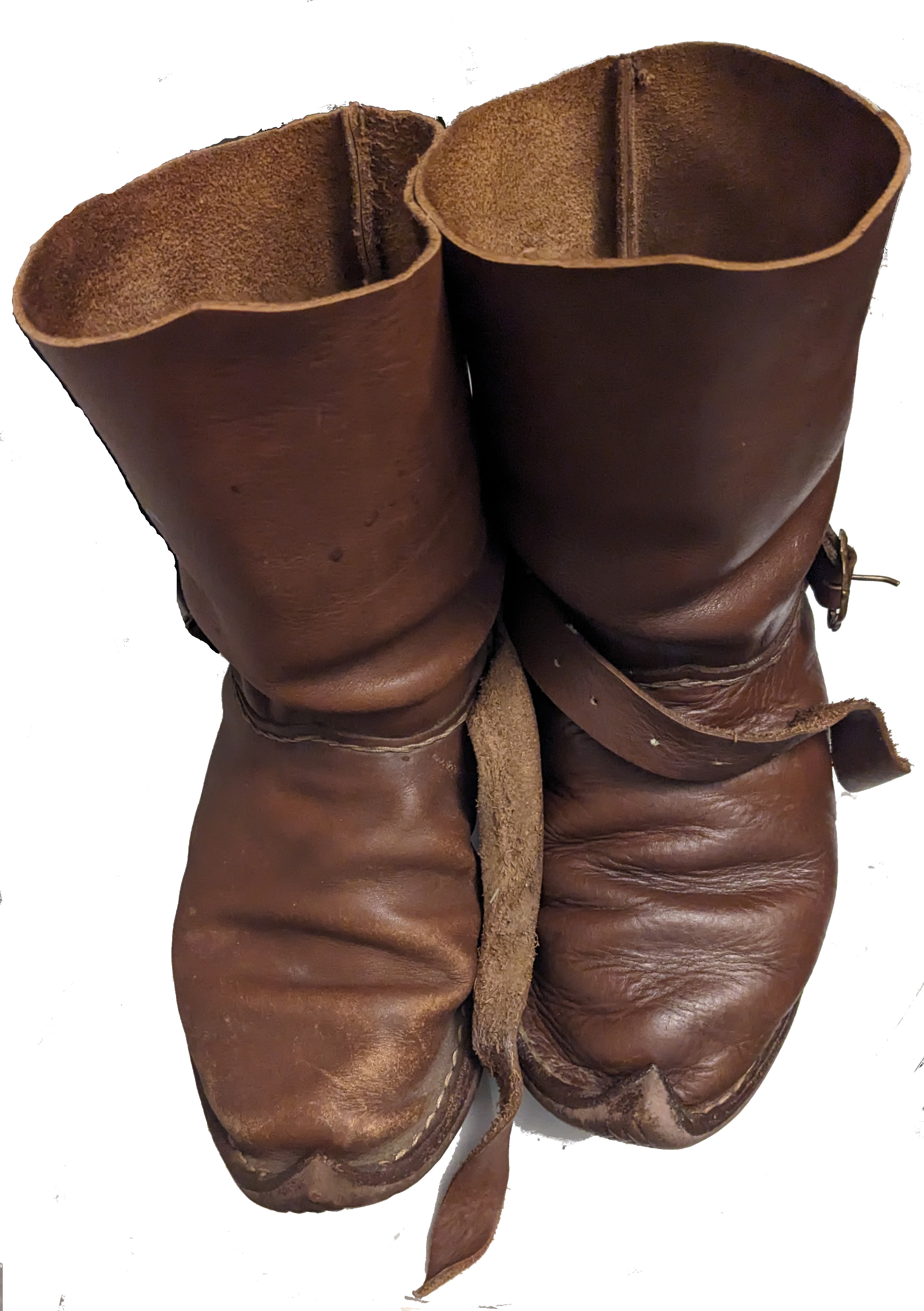 Pair of brown leather boots with white background. The one on the right is slightly darker and shinier