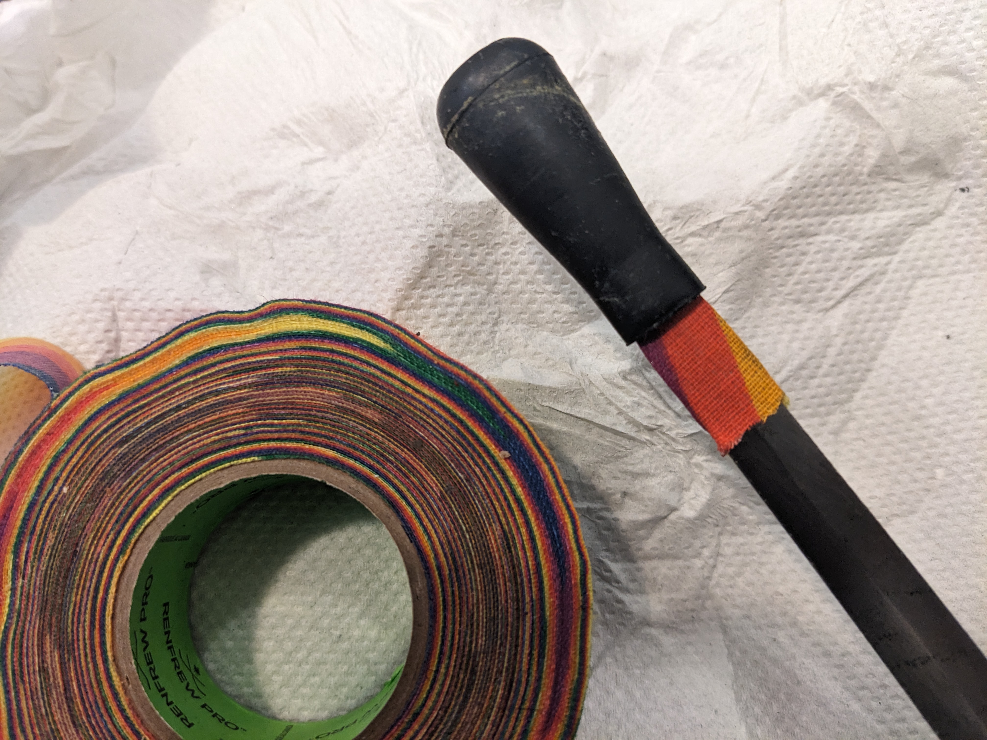 Dagger with black rubber tip, layer of rainbow tape under tip only