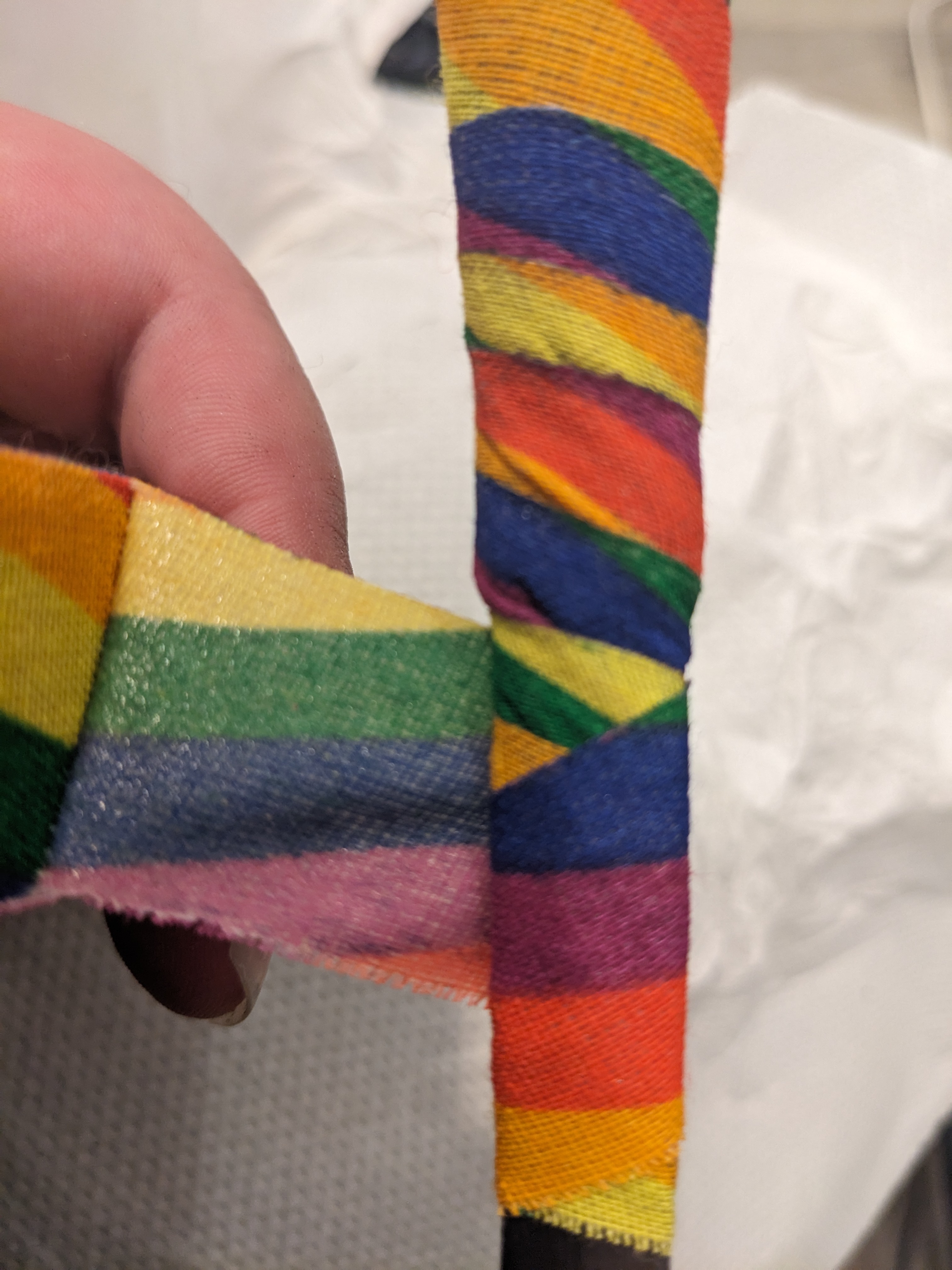 Dagger tip with black rubber tip, wrapped in rainbow tape, second wrap