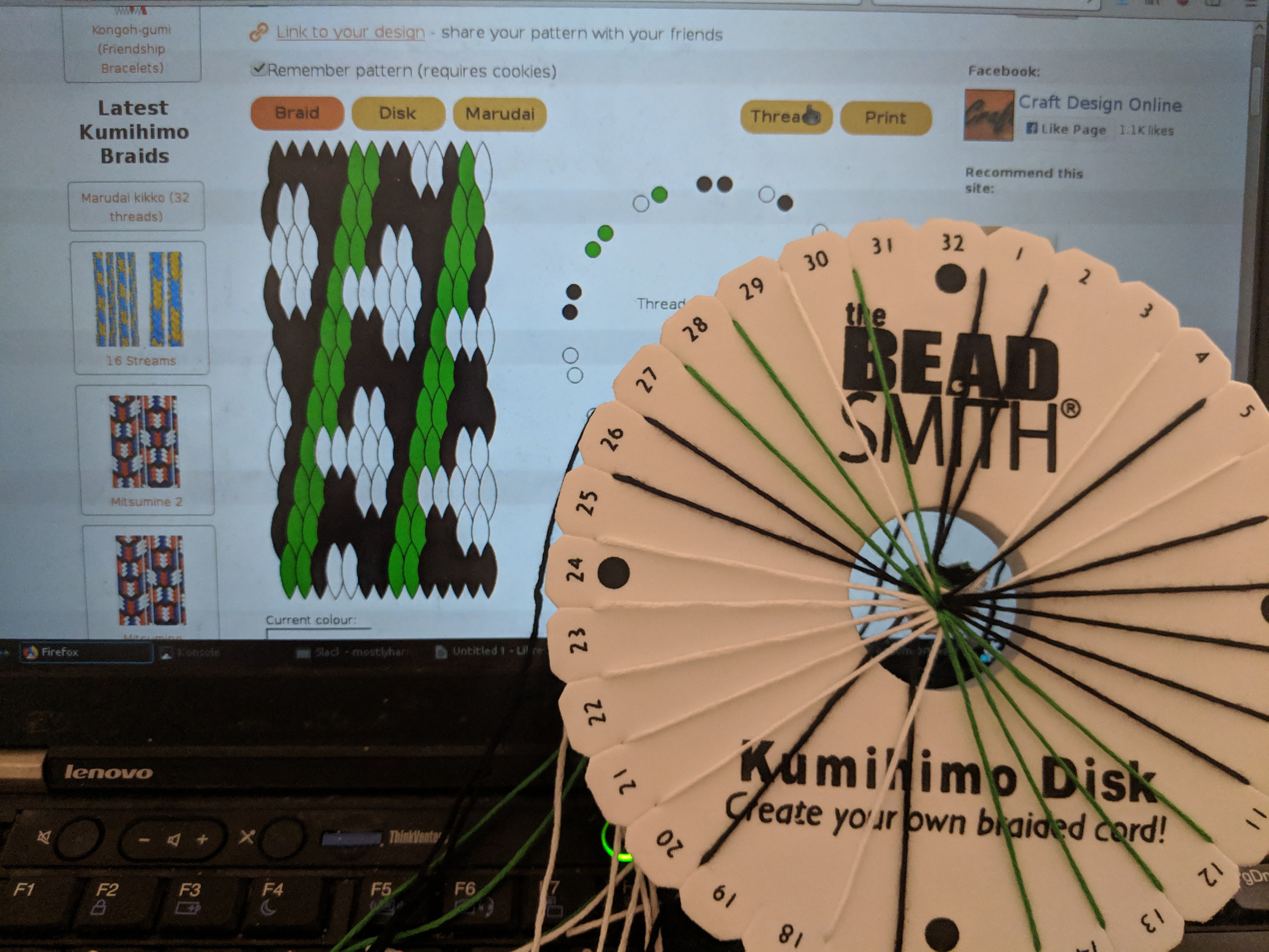 Picture of a threaded kumihimo disk in front of a computer screen with a kumihimo pattern on it 